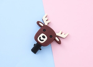 Close-up of a brown silicone reindeer cartoon hair clip with a black metal duckbill base