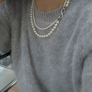 Double-layered pearl necklace with zircon-set infinity symbol on silver-tone metal