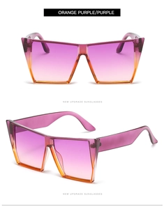 Close-up of oversized square sunglasses with purple and orange gradient lenses and wide temples