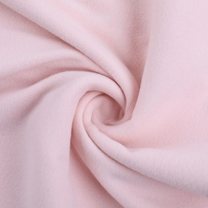 Dettaglio ravvicinato del tessuto a maglia rosa morbido con texture arricciata fine