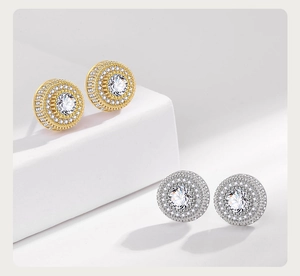 Detailed close-up of hip hop zircon stud earrings in gold and silver finishes