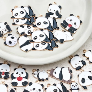 Detailed macro view of assorted panda enamel charms with polished gold metal borders