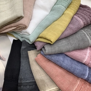 Close-up of lightweight linen lace scarves in multiple colors for spring fashion