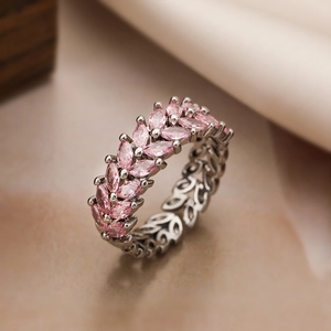 Detail of gold-plated ring with pink marquise-cut zircons in wheat leaf design