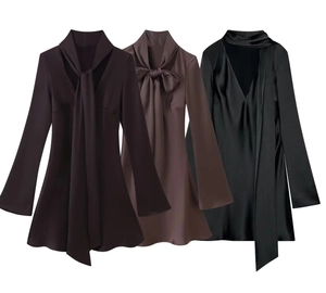 Detail view of satin dress featuring tie-neck bow and deep V-neck in multiple colors