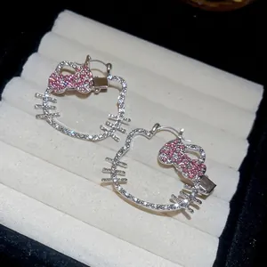 Sparkling cat earrings with cubic zirconia in a beige jewelry box for a luxury look