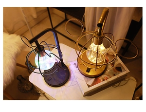 Black and gold Mickey-shaped LED night lamps with warm glow on a cozy white table