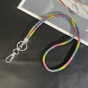 Detailed macro of rainbow rhinestone phone strap with silver lobster clasp and metal ring