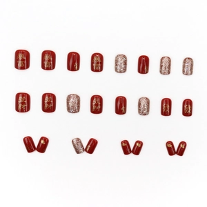 Festive red short press-on nails with gold glitter and Chinese character lucky symbols