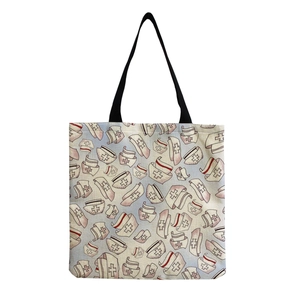 Detail of vintage nurse cap print on off-white canvas tote bag with black handles