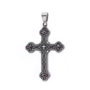 Vintage silver Viking cross pendant with red gemstones on white background