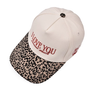 Close-up of leopard print brim and red embroidery on a vintage canvas baseball cap