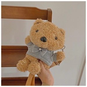 Close-up of brown plush bear crossbody bag with grey bow and pearl decorative details