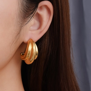 Minimalist double-layered gold starfish stud earrings on model for summer beach vacation