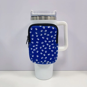 Detail of blue neoprene sleeve with white paw prints and zipper for 40oz tumbler