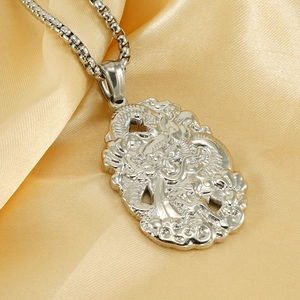 Silver dragon relief pendant in stainless steel with 18K gold plating on silk background