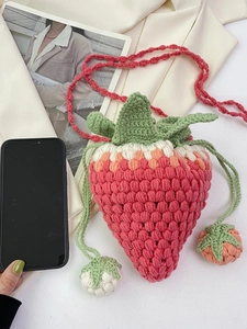 Handmade crochet strawberry crossbody bag for girls with green leaves and a red strap