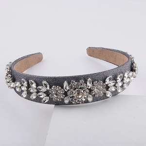 Detail of baroque headband with sparkling crystals on grey background in 45-degree view