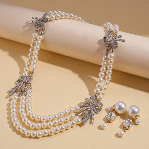 Elegant multilayer baroque pearl necklace set with rhinestone bow pendant and earrings