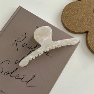 Dettaglio molletta per capelli in acetato bianco perla con scritta France handmade