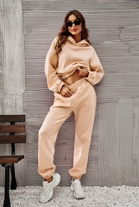 Detailed texture of women's apricot hooded sweatshirt and matching jogger pants set