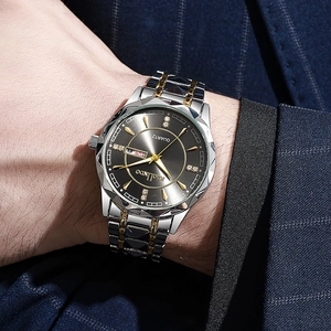 Close-up of RIOLINDO two-tone men's watch featuring a dark dial with day-date display