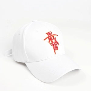 Macro detail of red embroidery on a white cotton baseball cap with high-quality stitching
