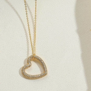 Close-up of gold heart pendant necklace featuring micro-pave cubic zirconia crystals