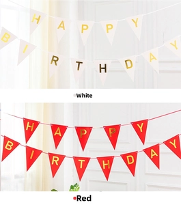 Close-up of white and red triangle banners with gold Happy Birthday foil lettering