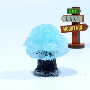 Macro detail of a handmade blue crystal gemstone tree on a clean background with wood signs