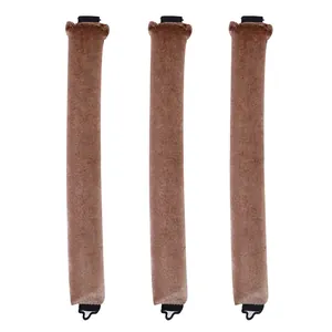 Detailed view of three brown velvet heatless hair curlers with black hooks on white background