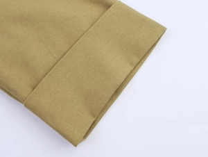 Detail shot of khaki linen blend fabric texture and professional hem stitching work