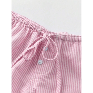 Close-up of pink and white striped pajama shorts showing drawstring and button details