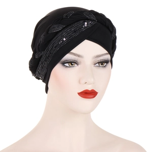 Detailed view of black turban hat featuring shiny silver sequins and braided trim