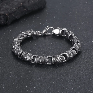 Macro detail of male punk snake bracelet with steel scales and lobster clasp closure