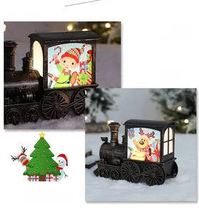 Detail of vintage bronze Christmas train lantern with glowing elf and reindeer illustrations