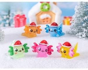 Macro view of five colorful resin axolotls with Christmas hats in a snowy miniature scene