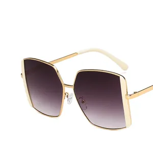 Oversized square sunglasses with gold metal frames and gradient lenses for women