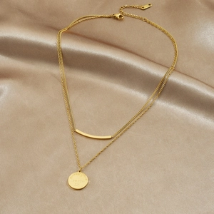 Double-layered gold stainless steel necklace with engraved round tag and bar pendant on satin