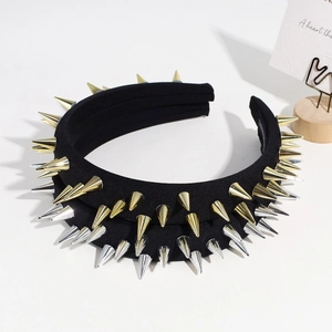 Detail of black punk headband with alternating gold and silver cone studs on fabric
