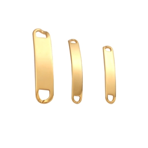 Close-up of curved golden stainless steel jewelry connectors with dual holes in three sizes