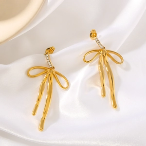 18k gold plated stainless steel bow earrings with zircon stones on white silk