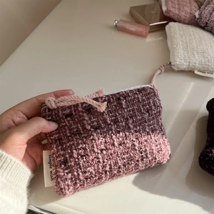 Detailed macro view of purple woven tweed mini coin purse with simple wish label and zipper