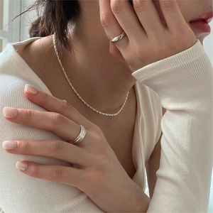 Minimalist 925 sterling silver beaded necklace and rings set worn by model