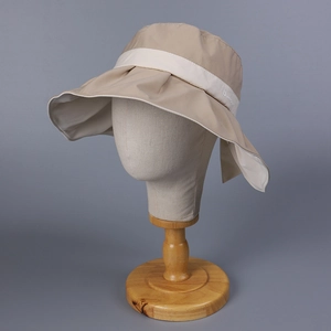 Detail of khaki wide brim sun hat featuring waterproof fabric and a stylish rear bow