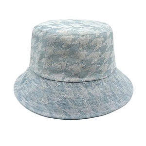 Detailed view of the woven blue houndstooth pattern and fabric texture on a bucket hat
