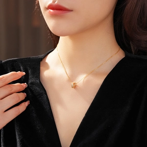 Close-up of 18K gold plated double ring necklace with shimmering pavé zircon stones