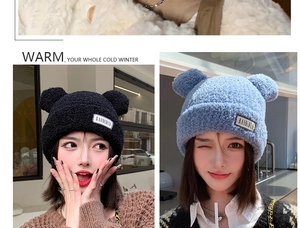 Close-up of thick plush knit hat featuring cute bear ears and a stitched letter patch