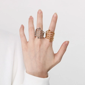 Minimalist spiral layered stainless steel rings with bead detail in gold and silver