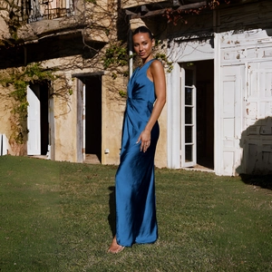 Détail de la robe élégante en satin bleu foncé montrant la texture lisse et le dos nu